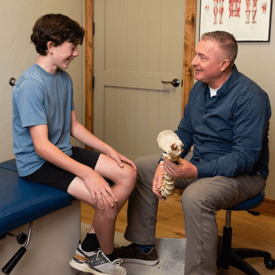 chiropractor with patient